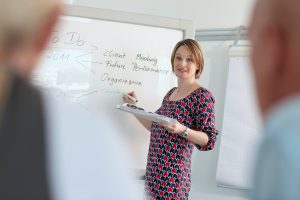 Businesswoman writing on whiteboard